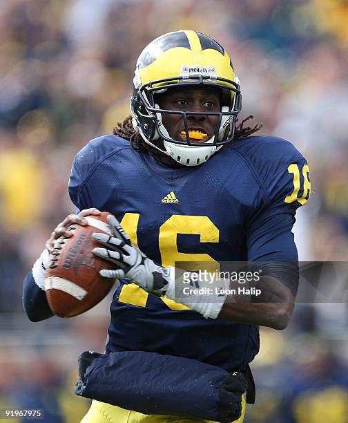 Denard Robinson of the Michigan Wolverines roles out to pass in the second quarter against the Delaware State Hornets at Michigan Stadium on October...