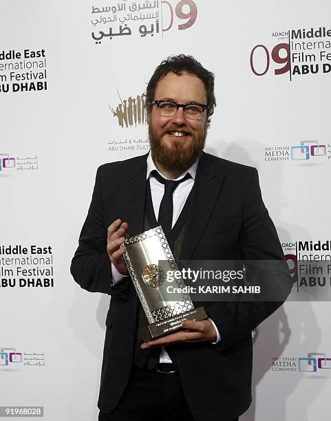 Australian filmmaker Glendyn Ivin holds his Black Pearl award for best new narrative director during the closing ceremony of the third annual Middle...