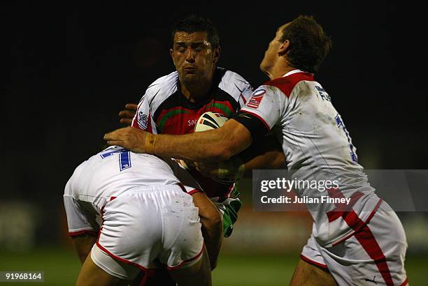 Geraint Davies of Wales is tackled by Richie Myler of England and Gareth Ellis of England during the Gillette Fusion International match between...