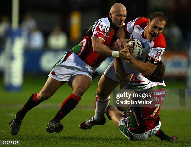 Gareth Ellis of England is tackled by Ian webster and Gil Dudson of Walesduring the Gillette Fusion International match between Wales and England at...