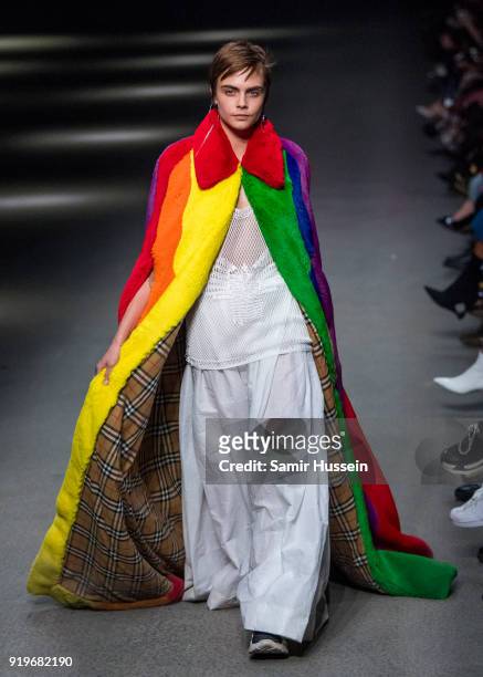 Cara Delevingne walks the runway at the Burberry show during London Fashion Week February 2018 at Dimco Buildings on February 17, 2018 in London,...