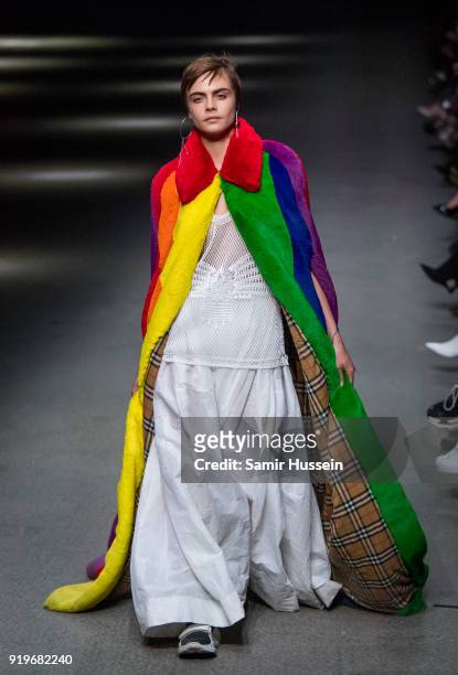 Cara Delevingne walks the runway at the Burberry show during London Fashion Week February 2018 at Dimco Buildings on February 17, 2018 in London,...