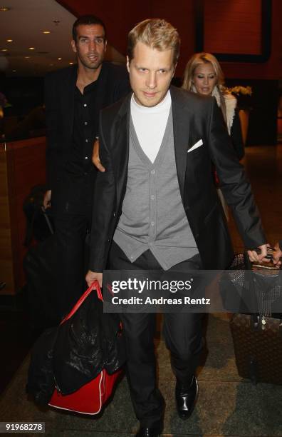 Oliver Pocher and Sandy Meyer Woelden leave the Hotel during the Mc Donalds Fundraising Gala at Hyatt Hotel on October 17, 2009 in Berlin, Germany.