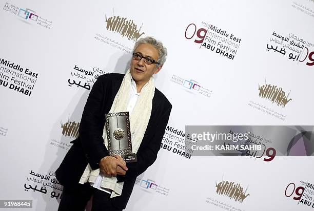 Palestinian director Elia Suleiman holds the Black Pearl award for best Middle Eastern narrative film during the closing ceremony of the third annual...