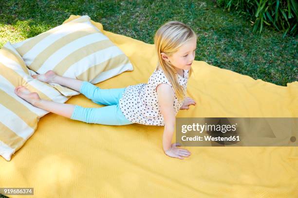 girl practicing yoga on a blanket - child yoga elevated view stock pictures, royalty-free photos & images