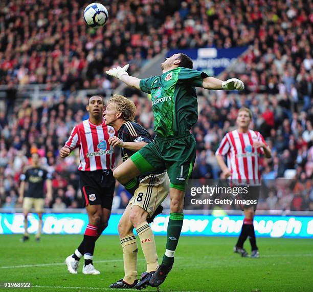 Sunderland goalkeeper Craig Gordon clears from Dirk Kuyt of Liverpool during the Barclays Premier League match between Sunderland and Liverpool at...