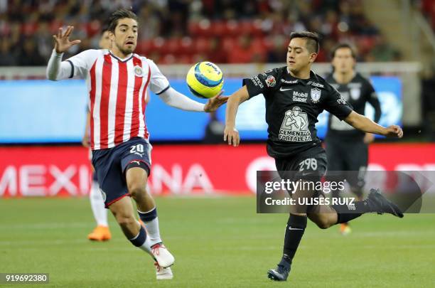 Guadalajara's midfielder Rodolfo Pizarro vies for the ball with Pachuca's midfielder Erick Sanchez during their Mexican Clausura 2018 tournament...