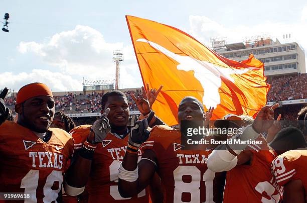 Emmanuel Acho, Kheeston Randall and Sam Acho of the Texas Longhorns celebrate a win against the Oklahoma Sooners at Cotton Bowl on October 17, 2009...