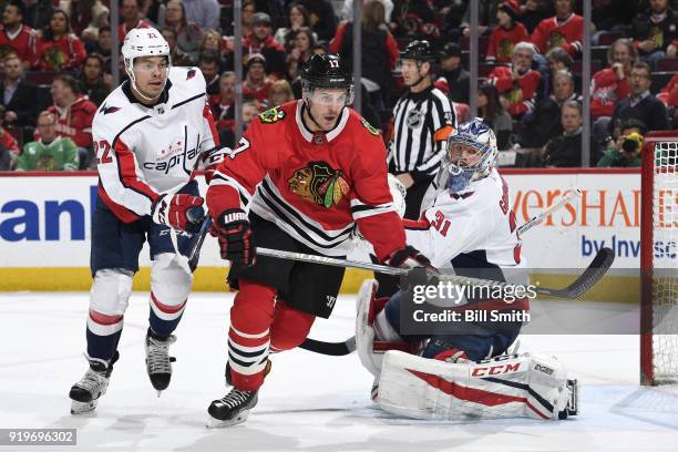 Lance Bouma of the Chicago Blackhawks and Madison Bowey of the Washington Capitals skate in front of goalie Philipp Grubauer in the third period at...