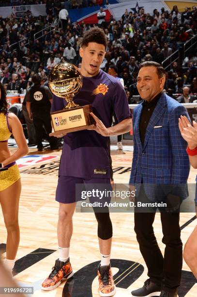 Devin Booker of the Phoenix Suns receives the champions trophy during the JBL Three-Point Contest during State Farm All-Star Saturday Night as part...