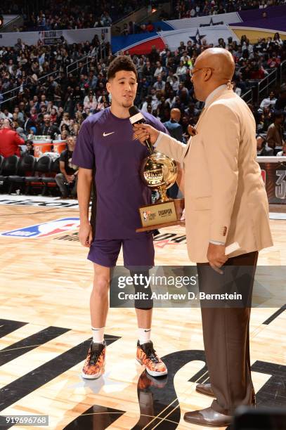 Devin Booker of the Phoenix Suns receives the champions trophy during the JBL Three-Point Contest during State Farm All-Star Saturday Night as part...