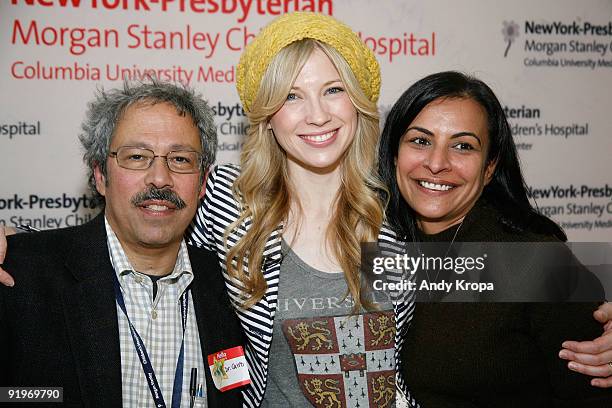 Brooke White, center, stands with Dr. Michell Cairo, Chief of the Division of Pediatric Blood and Marrow Transplantation, left, and attending...