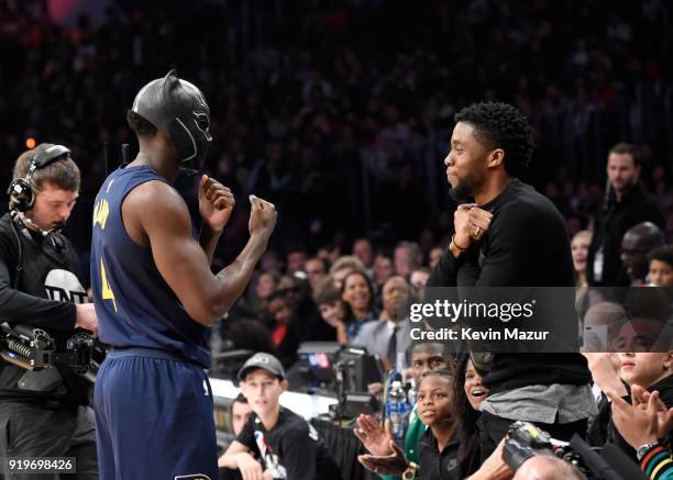 Player Victor Oladipo of the Indiana Pacers puts on Marvel's Black Panther mask from Chadwick Boseman during the 2018 State Farm All-Star Saturday...