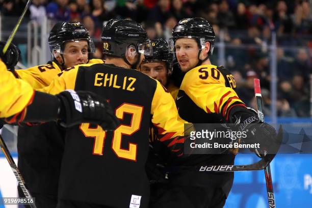 Patrick Hager of Germany celebrates with teammates after scoring a goal in the second period against Norway during the Men's Ice Hockey Preliminary...