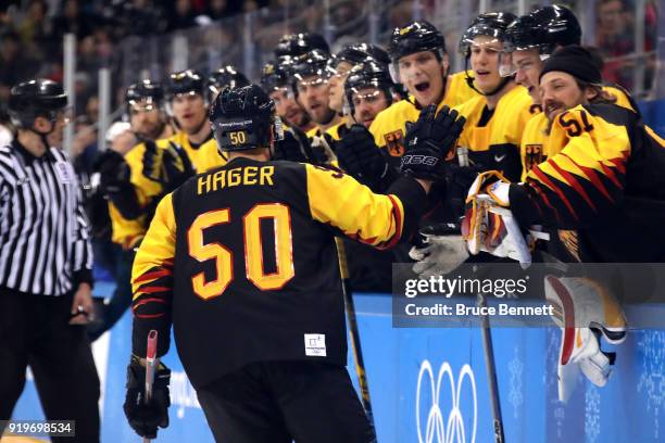 Patrick Hager of Germany celebrates with teammates after scoring a goal in the second period against Norway during the Men's Ice Hockey Preliminary...