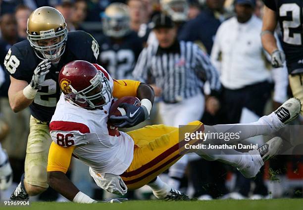 Tight end Anthony McCoy of the USC Trojans is taken down by safety Kyle McCarthy of the Notre Dame Fighting Irish in the second quarter of the game...