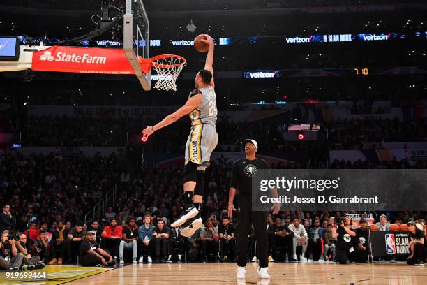 Larry Nance Jr. #24 of the Cleveland Cavaliers dunks the ball assisted by his father Larry Nance Sr. During the Verizon Slam Dunk Contest during...