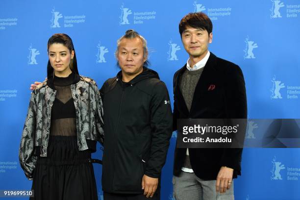 Mina Fujii, Kim Ki-duk and Lee Sung-jae pose for a photo during a photo-call on the film "Human, Space, Time and Human"' during the 68th Berlinale...