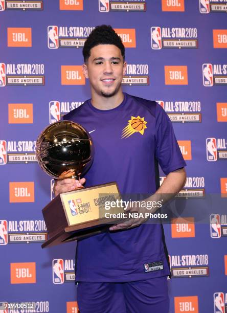 Devin Booker of the Phoenix Suns poses with his trophy following his victory in the JBL Three-Point Contest during State Farm All-Star Saturday Night...