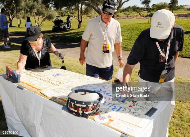 Fans sign a banner supporting U.S. Troops and their families at the Military Outpost during the third round of the Justin Timberlake Shriners...