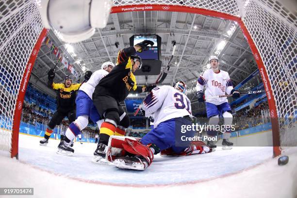 Patrick Hager of Germany scores against Lars Haugen of Norway in the second period during the Men's Ice Hockey Preliminary Round Group B game on day...