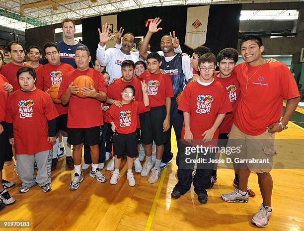 Primoz Brezec, Randy Ayers, and Willie Green of the Philadelphia 76ers pose for a photo with kids during an NBA Cares Special Olympics Basketball...