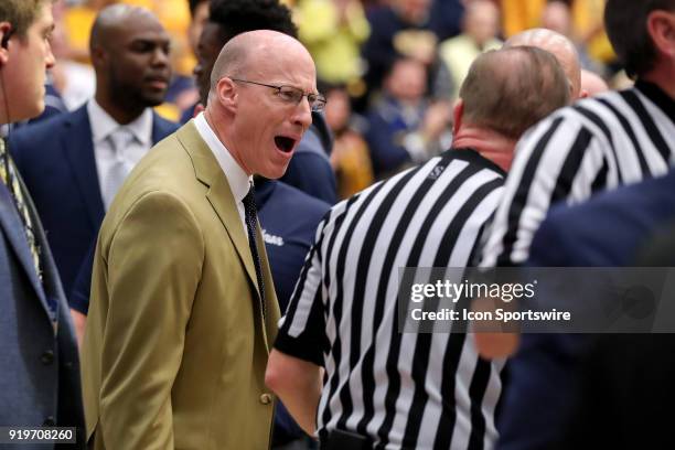 Akron Zips head coach John Groce argues with an official as he leaves the court after the first half of the men's college basketball game between the...