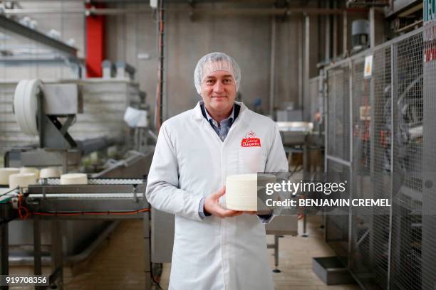 Of 'Garcia Baquero' cheese manufacturer, Miguel Angel Garcia Baquero poses holding a Manchego cheese in the company's factory of Alcazar de San Juan...