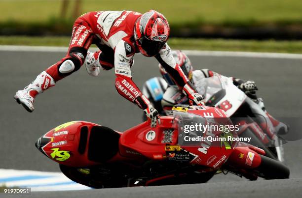 Alvaro Bautista of Spain and the Mapfre Aspar Team crashes during 250 cc warm up session prior to the Australian MotoGP, which is round 15 of the...
