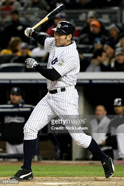Johnny Damon of the New York Yankees hits a single to left field against the Los Angeles Angels of Anaheim in Game Two of the ALCS during the 2009...