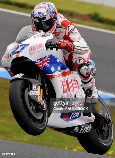 Casey Stoner of Australia lifts the front wheel of his Ducati during the warm-up session for the Australian MotoGP Grand Prix at Phillip Island on...