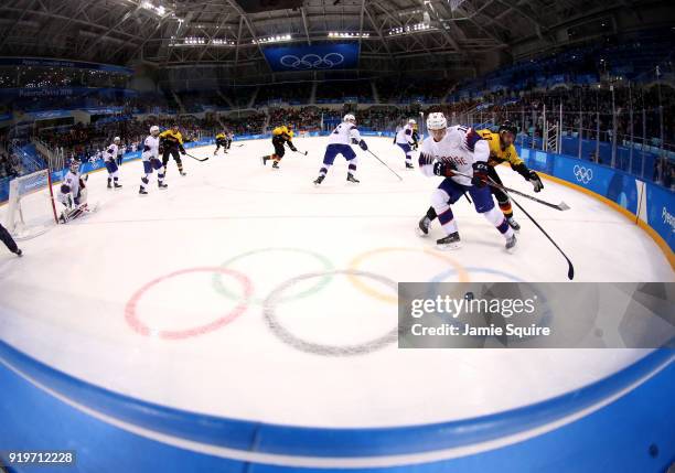 Mattias Norstebo of Norway and Marcus Kink of Germany compete for the puck in the third period during the Men's Ice Hockey Preliminary Round Group B...