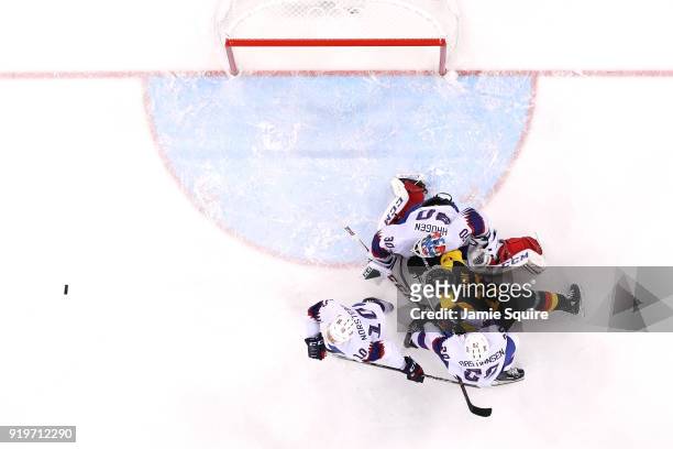 Marcus Kink of Germany competes for the puck in the second period against Mattias Norstebo, Anders Bastiansen and Lars Haugen of Norway during the...