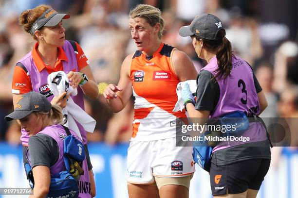 Cora Staunton of GWS comes off with a facial injury after trying to tackle Sophie Casey of the Magpies during the round three AFLW match between the...
