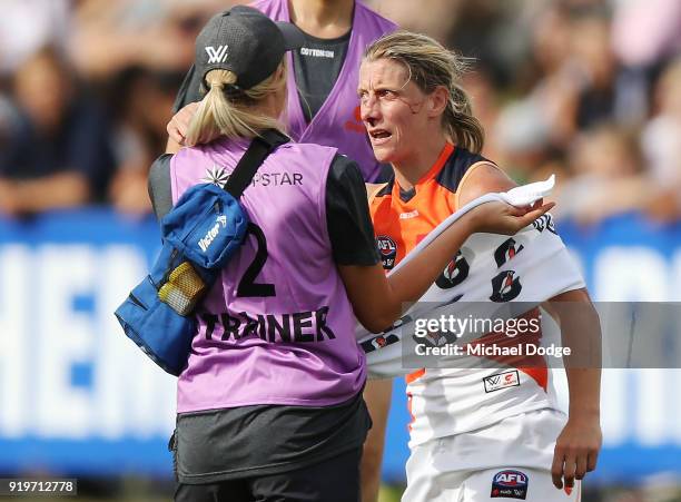 Cora Staunton of GWS comes off with a facial injury after trying to tackle Sophie Casey of the Magpies during the round three AFLW match between the...