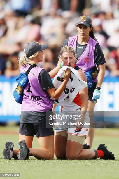 Cora Staunton of GWS comes off with a facial injury after trying to tackle Sophie Casey of the Magpies during the round three AFLW match between the...
