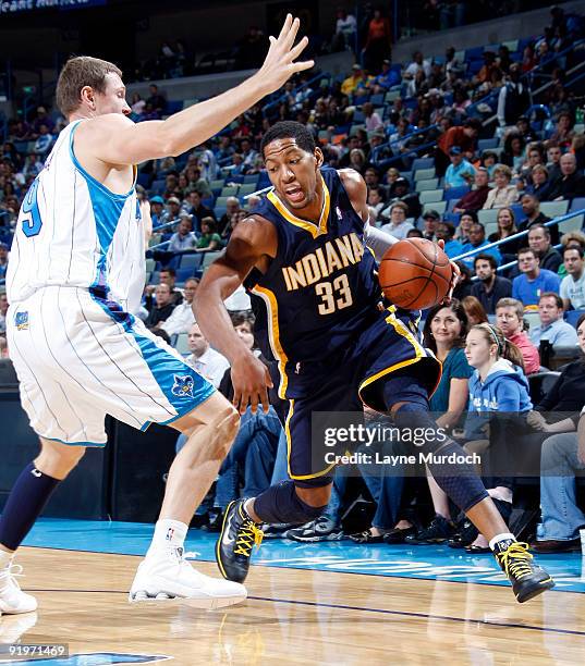 Danny Granger of the Indiana Pacers drives on Darius Songaila the New Orleans Hornets on October 17, 2009 at the New Orleans Arena in New Orleans,...