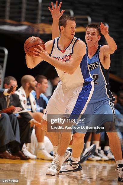 Steve Novak of the Los Angeles Clippers holds the ball against Spencer Nelson of the Utah Jazz at Staples Center on October 17, 2009 in Los Angeles,...