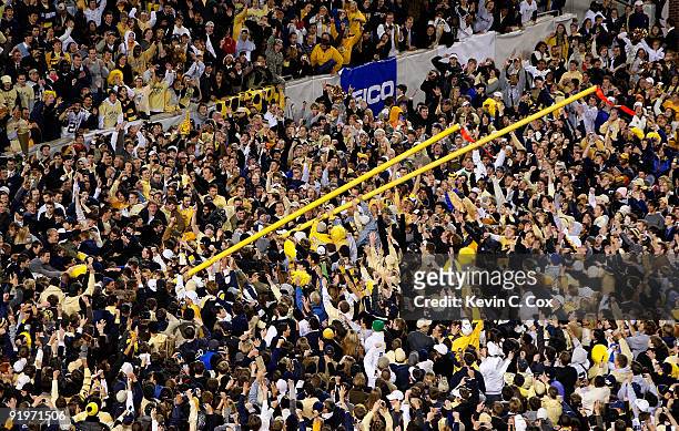 Fans bring down the goal post in the North End Zone after the Georgia Tech Yellow Jackets 28-23 win over the Virginia Tech Hokies at Bobby Dodd...