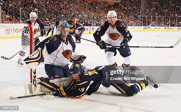 Tim Kennedy of the Buffalo Sabres crashes into goaltender Johan Hedberg the Atlanta Thrashers with Christoph Schubert of the Thrashers following the...