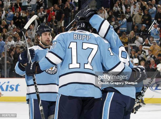Mike Rupp of the Pittsburgh Penguins celebrates his goal with Eric Godard and Sidney Crosby against the Tampa Bay Lightning on October 17, 2009 at...
