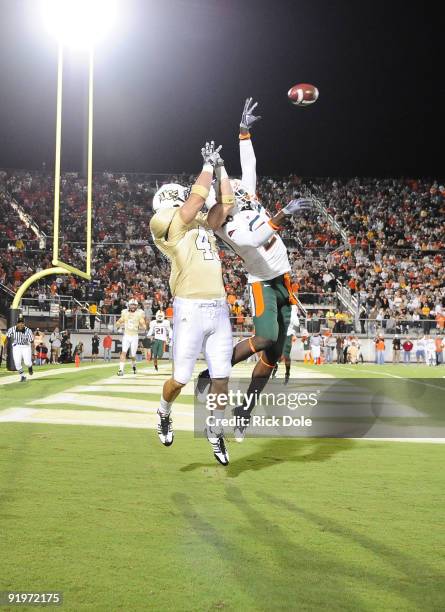 Strong safety Ray Ray Armstrong of the Miami Hurricanes breaks up a pass intended for half back Ricky Kay of the Central Florida Knights, at Bright...