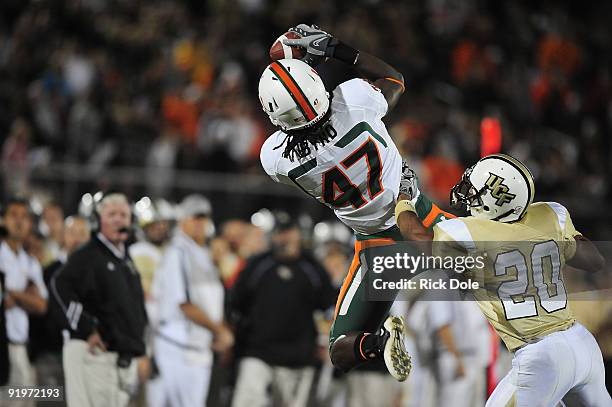 Wide Receiver LaRon Byrd of the Miami Hurricanes catches a reception against cornerback Josh Robinson of the Central Florida Knights, at Bright House...