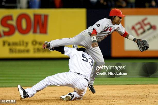 Erick Aybar of the Los Angeles Angels of Anaheim misses the bag and Melky Cabrera of the New York Yankees is safe at second base in the bottom of the...