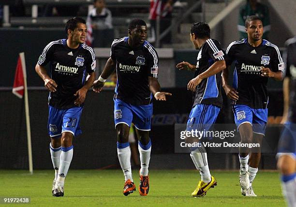 Brandon McDonald of the San Jose Earthquakes celebrates his goal with teammate Arturo Alvarez as teammate Ramon Sanchez looks on after McDonald...