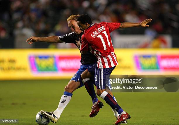 Maykel Galindo of Chivas USA challenges Simon Elliott of the San Jose Earthquakes for the ball in the first half during the MLS match at The Home...