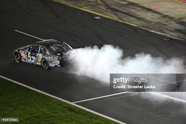 Smoke is seen coming from the car of Carl Edwards, driver of the Aflac Ford, during the NASCAR Sprint Cup Series NASCAR Banking 500 at Lowe's Motor...