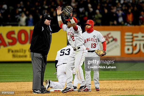 Erick Aybar of the Los Angeles Angels of Anaheim reacts to a call by second base umpire Jerry Layne that Melky Cabrera of the New York Yankees was...