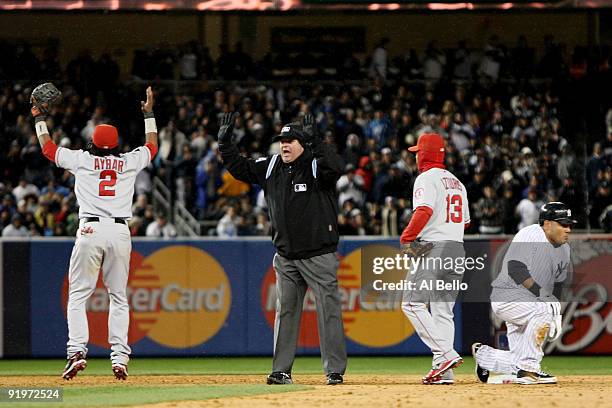 Erick Aybar of the Los Angeles Angels of Anaheim reacts to a call by second base umpire Jerry Layne that Melky Cabrera of the New York Yankees was...