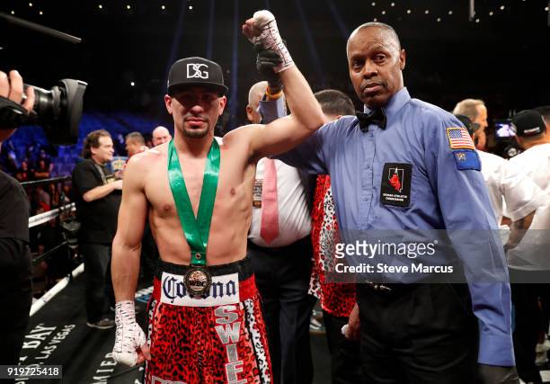 Danny Garcia poses with referee Kenny Bayless after defeating Brandon Rios in a welterweight boxing match at the Mandalay Bay Events Center on...